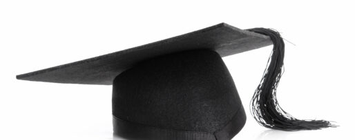 Black graduation cap shot over white background