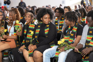 grads with kente cloths during black graduation night 2024