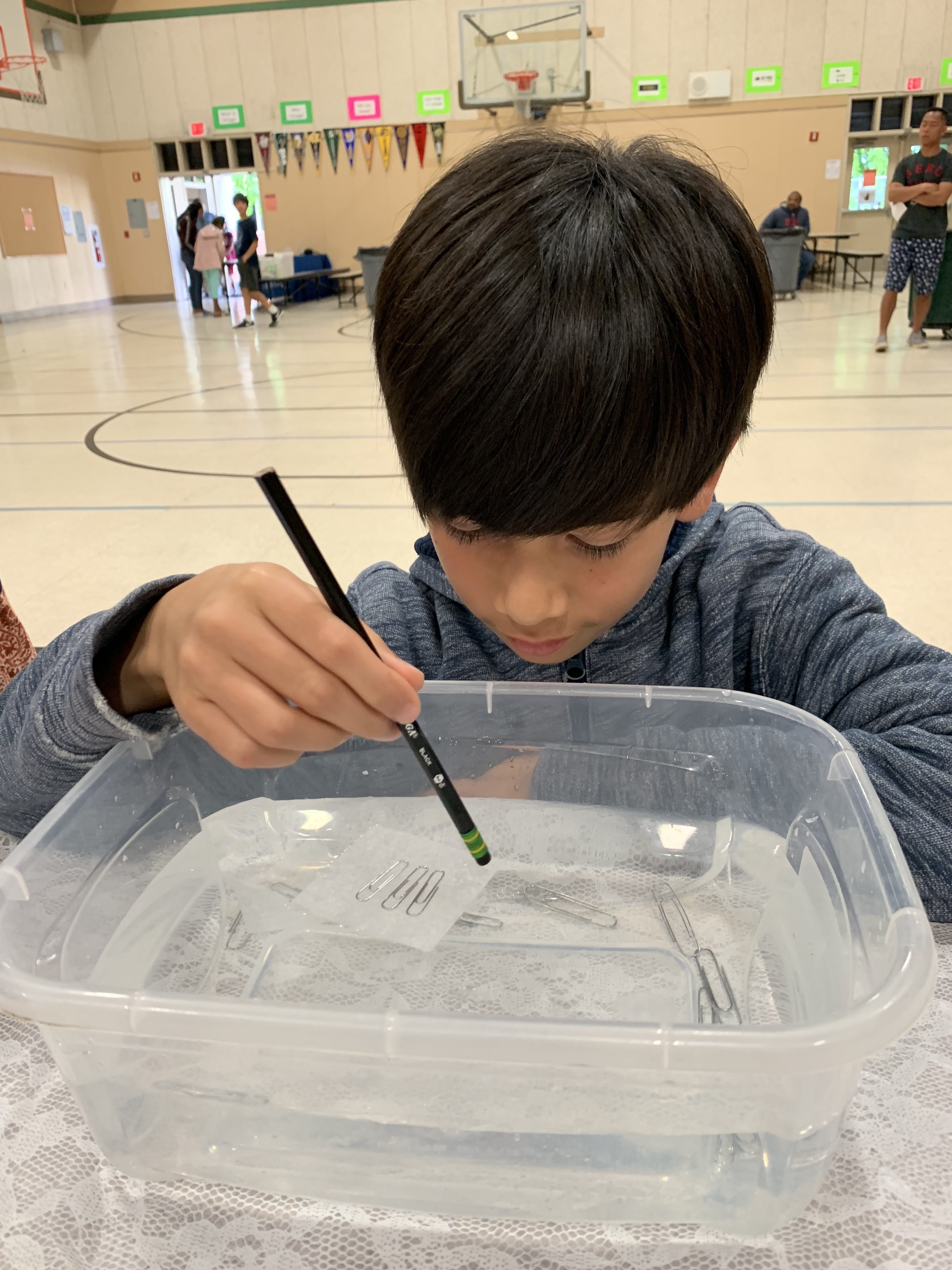 Student playing with water at Family Science Night