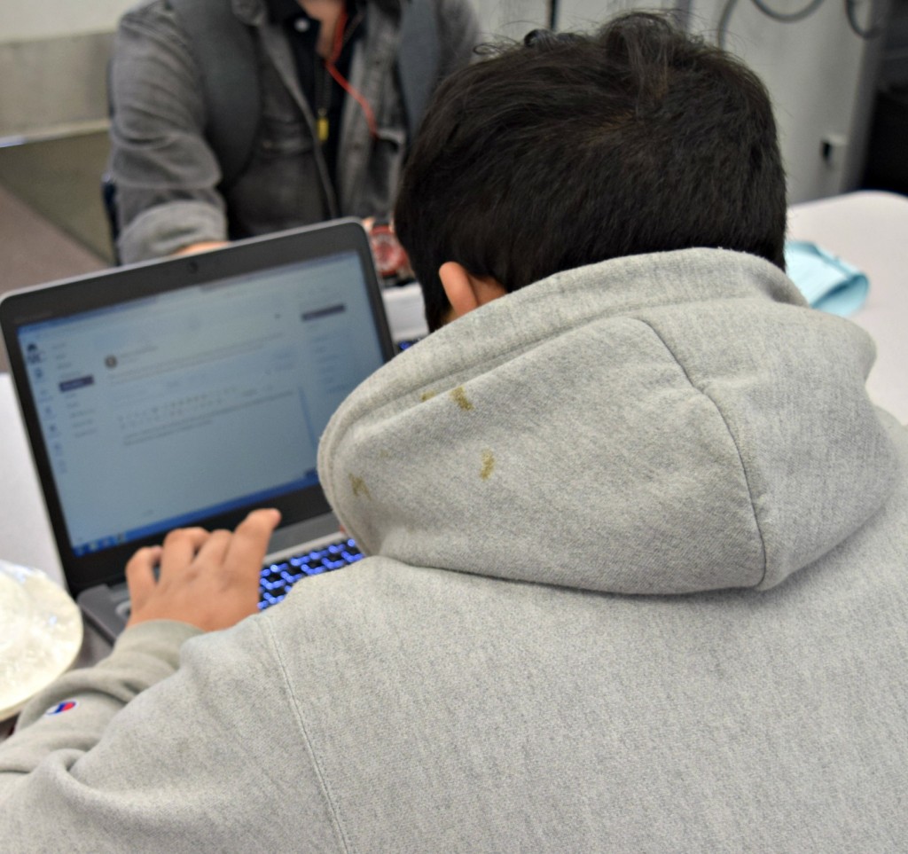 Student checks his computer in DiscoverARC class