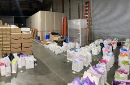 Warehouse full of white gift bags with colorful wrapping paper