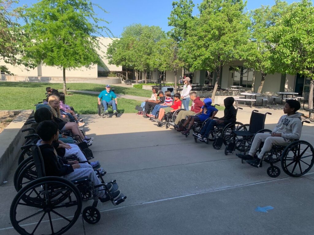 Students in wheelchairs at A Touch of Understanding assembly